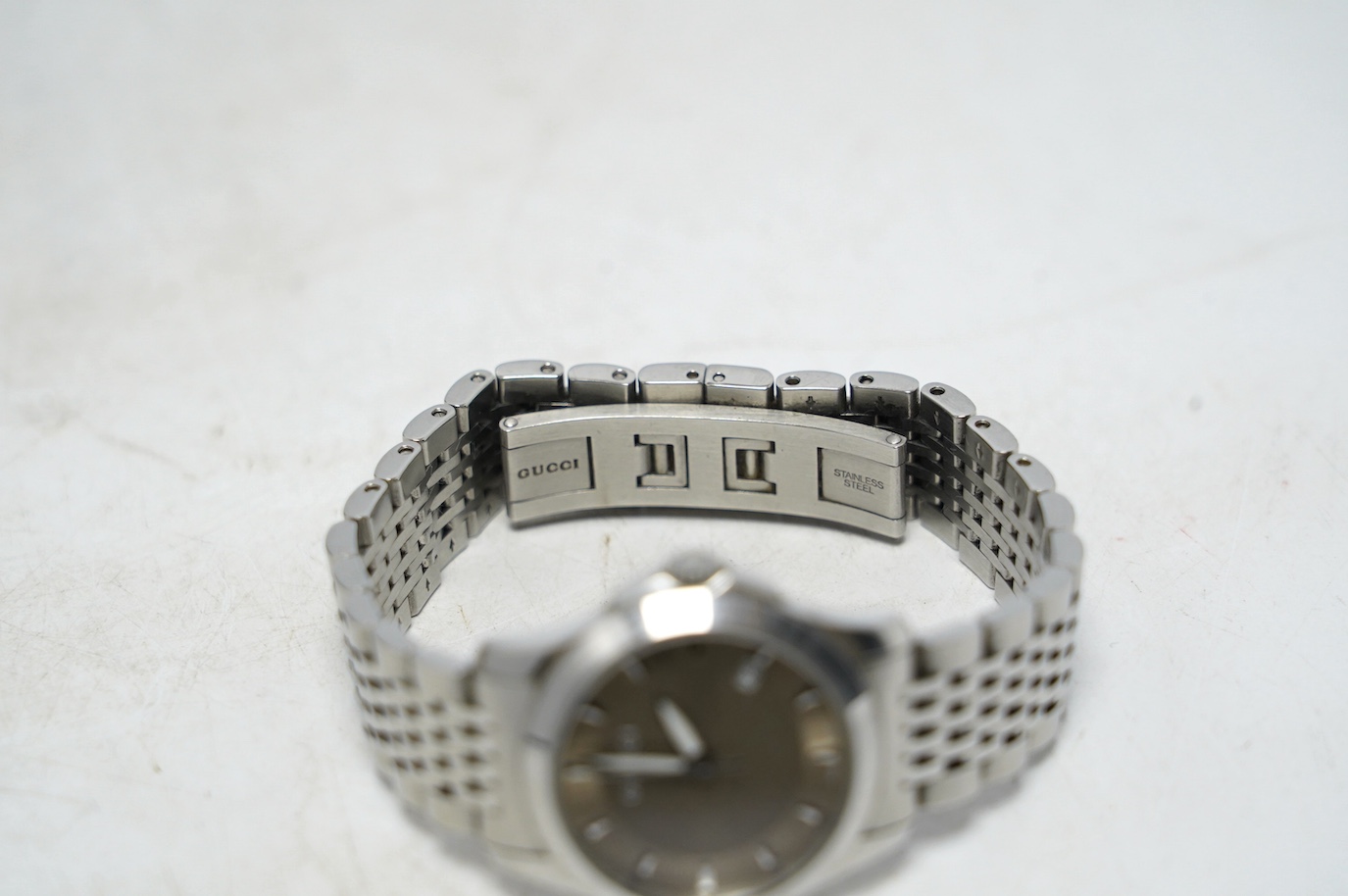 A lady's modern stainless Gucci quartz wrist watch, with date aperture, box and booklet. Condition - fair